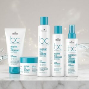 Commercial display of the Schwarzkopf Professional BC Bonacure Moisture Kick Clean Performance hair care line, featuring the Curl Bounce, Treatment, Shampoo, Conditioner, and Spray Conditioner on a marble surface with a hydrating water background.