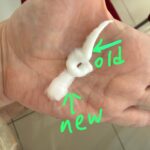 Hand holding two samples of white cream, digitally labeled with green arrows as "old" and "new" to compare product texture.