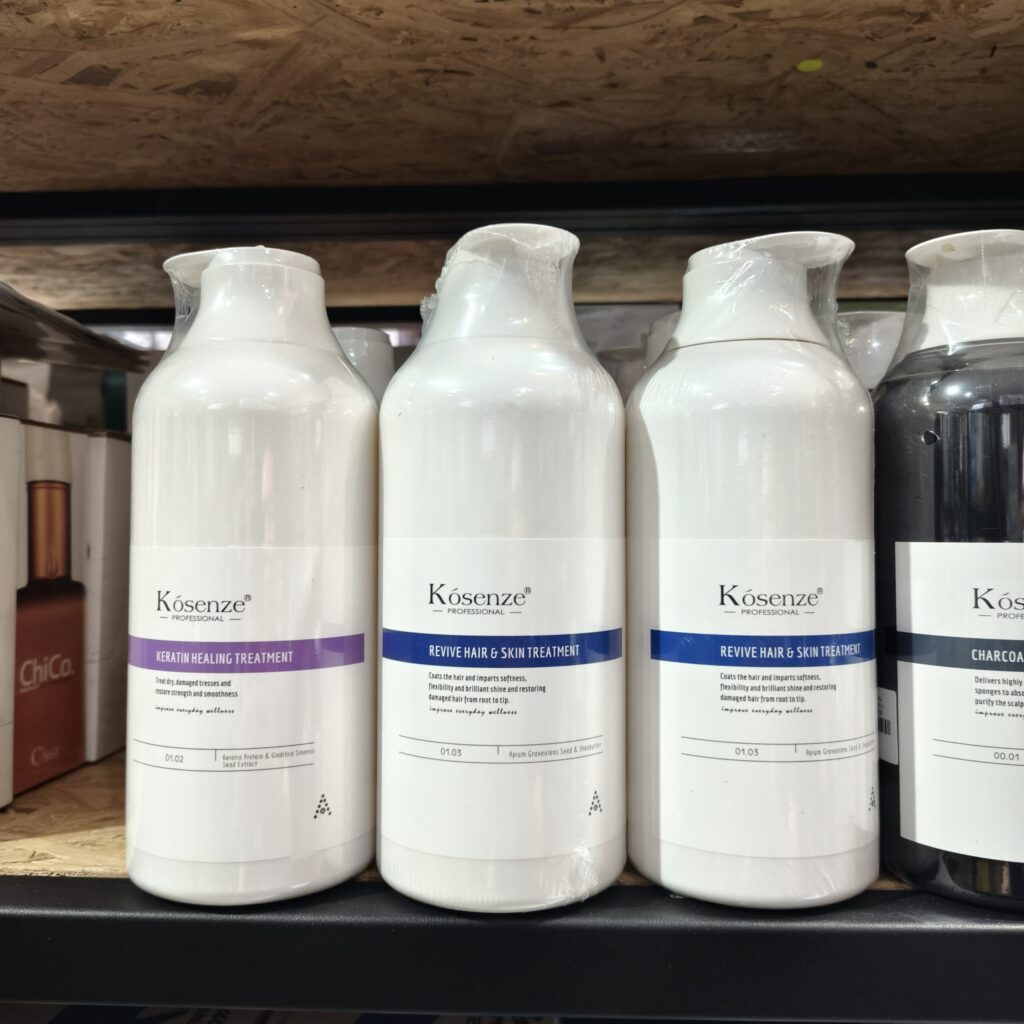 A shelf view of Kósenze treatment bottles featuring Keratin Treatment, Revive Treatments, and Charcoal Shampoo.