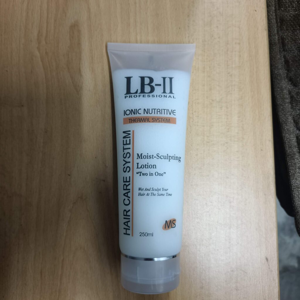 LB-II Professional Moist-Sculpting Lotion 250ml white squeeze tube resting on a light wooden surface.