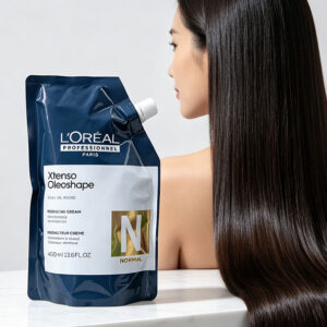 A sleek L'Oreal X-Tenso Oleoshape hair straightening cream bottle on a clean white marble surface, next to a woman with long super straight silky shiny Asian hair flowing down, soft studio lighting, high-end product photography, before-after concept, minimalist and elegant