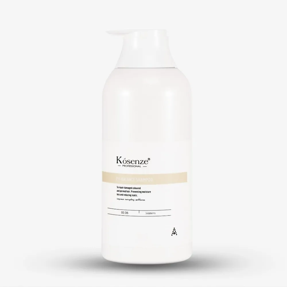 Front label of bottle Kósenze pH-Balance Shampoo featuring a pastel yellow accent stripe.