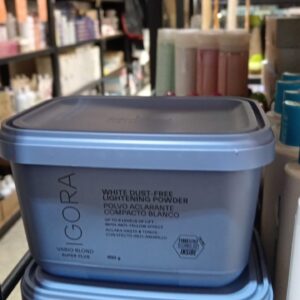 Two stacked 450g light blue tubs of IGORA Vario Blond Super Plus White Dust-Free Lightening Powder on a retail shelf.